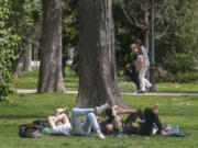 FILE - People relax in the Retiro park in Madrid, Spain, Wednesday, March 20, 2024. Copernicus has reported that March marked the 10th straight month of record monthly temperatures. Europe is the fastest-warming continent and its temperatures are rising at roughly twice the global average, two top climate monitoring organizations reported Monday, April 22, 2024, warning of the consequences for human health, glacier melt and economic activity.