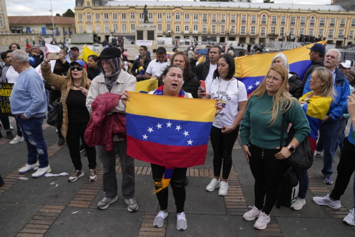 Supporters of opposition leader Mar&iacute;a Corina Machado sing their national anthem during a protest demanding free and fair elections in Venezuela&rsquo;s upcoming election, in Bolivar Square in Bogota, Colombia, Saturday, April 6, 2024.