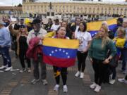 Supporters of opposition leader Mar&iacute;a Corina Machado sing their national anthem during a protest demanding free and fair elections in Venezuela&rsquo;s upcoming election, in Bolivar Square in Bogota, Colombia, Saturday, April 6, 2024.
