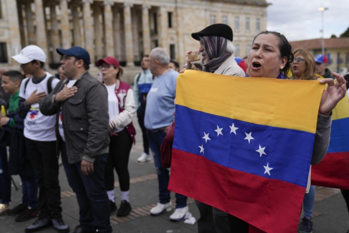 Supporters of Venezuelan opposition leader Mar&iacute;a Corina Machado sing their national anthem during a protest demanding free and fair elections in Venezuela&rsquo;s upcoming balloting on April 6 in Bogota, Colombia.