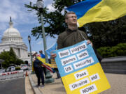 Activists supporting Ukraine demonstrate outside the Capitol in Washington, Saturday, April 20, 2024, as the House prepares to vote on approval of $95 billion in foreign aid for Ukraine, Israel and other U.S. allies. (AP Photo/J.