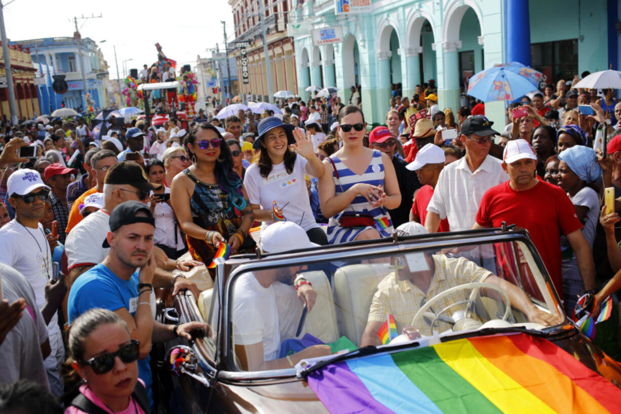 FILE - Mariela Castro, director of Cuba&rsquo;s National Center for Sexual Education, waves from a convertible classic car during a parade marking the International Day Against Homophobia, Transphobia and Biphobia, in Pinar Del Rio, Cuba, May 17, 2018. For years, the movement for LGBTQ+ rights has been proudly led by Cuba&rsquo;s best-known advocate for gay rights: Mariela Castro, daughter of former President Raul Castro and niece of his brother Fidel.