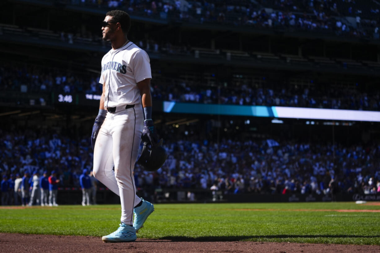 Seattle Mariners&#039; Julio Rodr&iacute;guez walks back to the dugout after being picked off at first base as a pinch runner by Chicago Cubs relief pitcher Adbert Alzolay in the ninth inning to end a baseball game Sunday, April 14, 2024, in Seattle. The Cubs won 3-2.