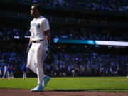 Seattle Mariners&#039; Julio Rodr&iacute;guez walks back to the dugout after being picked off at first base as a pinch runner by Chicago Cubs relief pitcher Adbert Alzolay in the ninth inning to end a baseball game Sunday, April 14, 2024, in Seattle. The Cubs won 3-2.