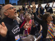 The Rev. K Karen, left, of St. Paul &amp; St. Andrew United Methodist Church in New York, joins other protesters in song and prayer outside the United Methodist Church&rsquo;s special session of the general conference in St. Louis on Feb. 26, 2019. Since 2019, the denomination has lost about one-fourth of its U.S. churches in a breakup focused in large part on whether to accept same-sex marriage and ordination of LGBTQ clergy.