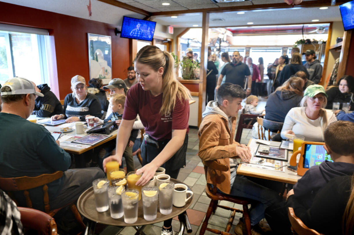 FILE - Waitress Rachel Gurcik serves customers at the Gateway Diner in Westville, Pa. on Oct. 22, 2023. On Friday, April 5, 2024, the U.S. government issues its March jobs report.