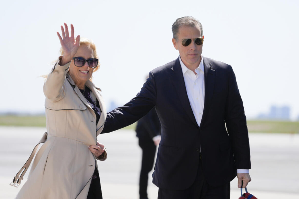 First lady Jill Biden waves as she walks with son Hunter Biden, to board Air Force One at John F. Kennedy International Airport, Friday, March 29, 2024, in New York.