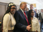 Republican presidential candidate former President Donald Trump, center, takes a photo with Michaelah Montgomery, left, a local conservative activist, as he visits a Chick-fil-A eatery, Wednesday, April 10, 2024, in Atlanta.