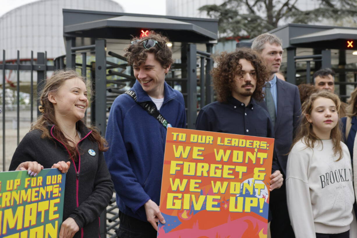 Swedish climate activist Greta Thunberg, left, joins youths from Portugal during a demonstration outside the European Court of Human Rights Tuesday, April 9, 2024 in Strasbourg, eastern France. Europe&rsquo;s highest human rights court will rule Tuesday on a group of landmark climate change cases aimed at forcing countries to meet international obligations to reduce greenhouse gas emissions. The European Court of Human Rights will hand down decisions in a trio of cases brought by a French mayor, six Portuguese youngsters and more than 2,000 elderly Swiss women who say their governments are not doing enough to combat climate change.