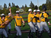 The members of the Evergreen baseball team celebrate after beating Kelso 4-0 in a 3A Greater St. Helens League game at Evergreen Sports Complex on Monday, April 22, 2024.