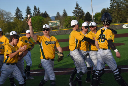 The members of the Evergreen baseball team celebrate after beating Kelso 4-0 in a 3A Greater St. Helens League game at Evergreen Sports Complex on Monday, April 22, 2024.