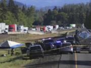 Traffic is backed up on Interstate 5 north of Eugene, Ore., as law enforcement secures the scene after a police chase Tuesday, April 23, 2024. A former Washington state police officer wanted after killing two people, including his ex-wife, was found dead with a self-inflicted gunshot wound following the chase, authorities said.