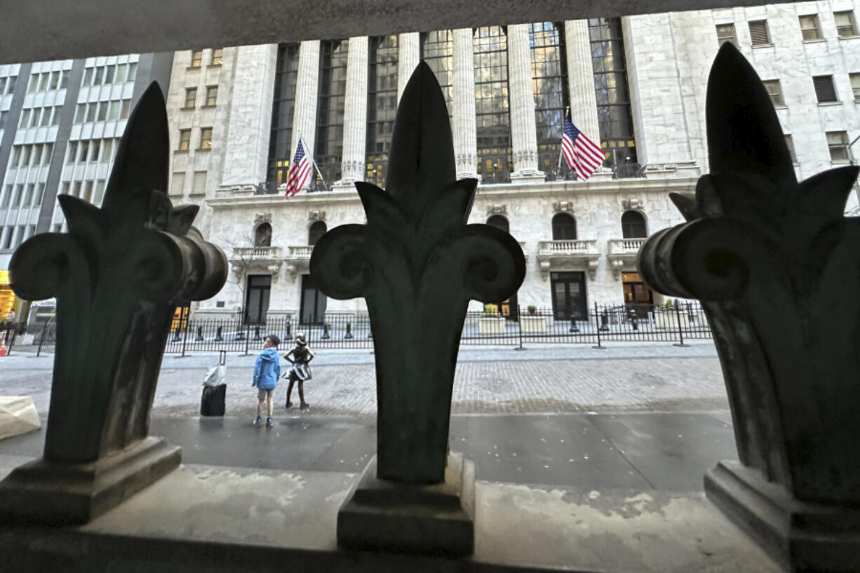 The New York Stock Exchange is seen, through a window guard, on Tuesday, April 16, 2024 in New York. Wall Street drifted toward gains as more corporate earnings come in, giving investors a break from fretting about if and when the Federal Reserve might cut interest rates.