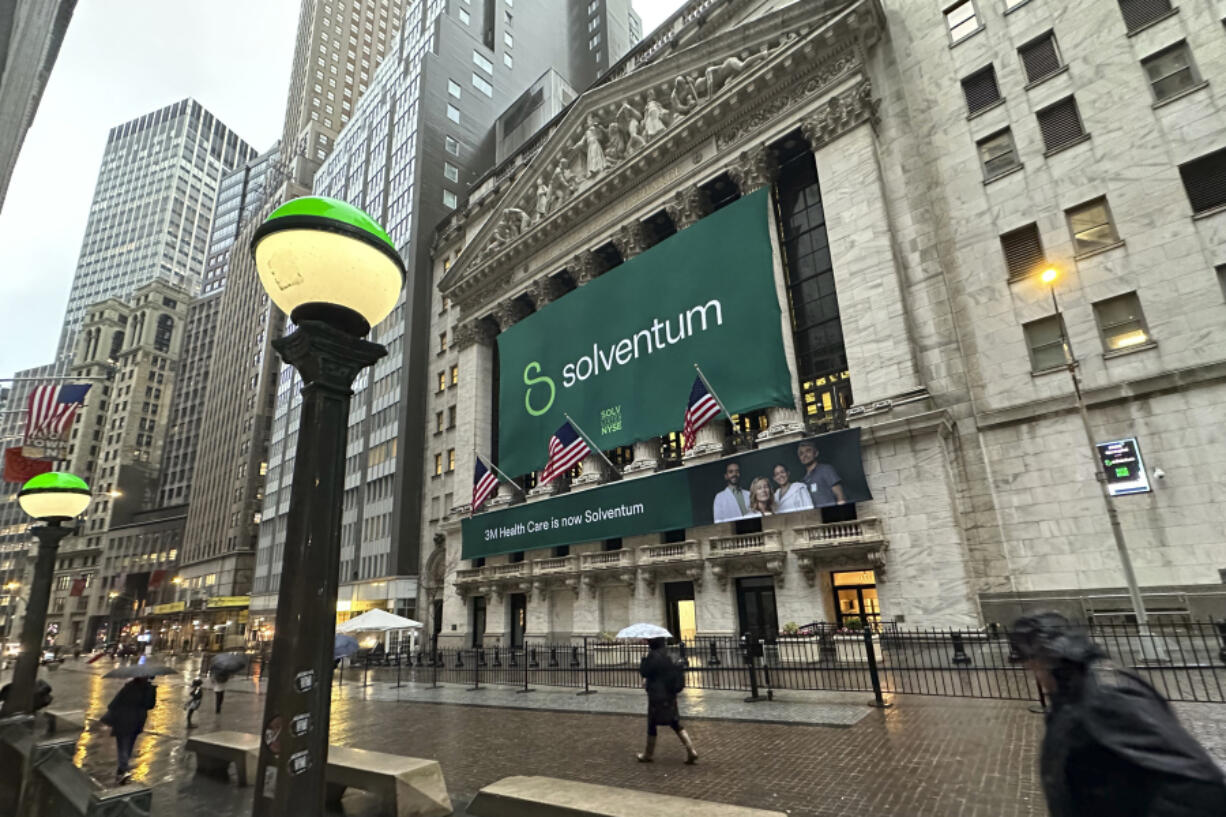 People walk past the New York Stock Exchange Wednesday, April 3, 2024 in New York. Healthcare business Solventum started trading at the NYSE on Wednesday.