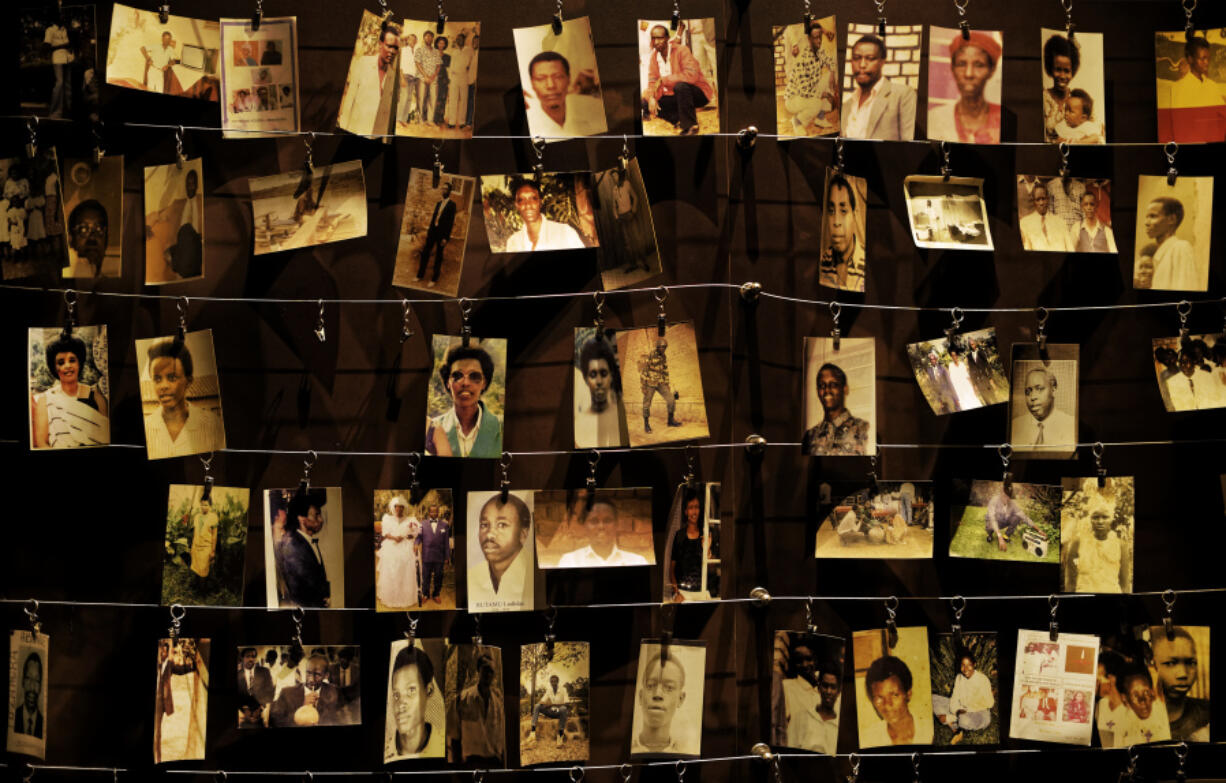 FILE - In this Friday, April 5, 2019 file photo, family photographs of some of those who died hang on display in an exhibition at the Kigali Genocide Memorial centre in the capital Kigali, Rwanda. French President Emmanuel Macron says France and its allies &ldquo;could have stopped&rdquo; the 1994 Rwanda genocide and &ldquo;lacked the will to do so.&rdquo; Macron&rsquo;s office said in a statement that the French president will release a video on Sunday as Rwanda commemorates the 30th anniversary of the genocide.