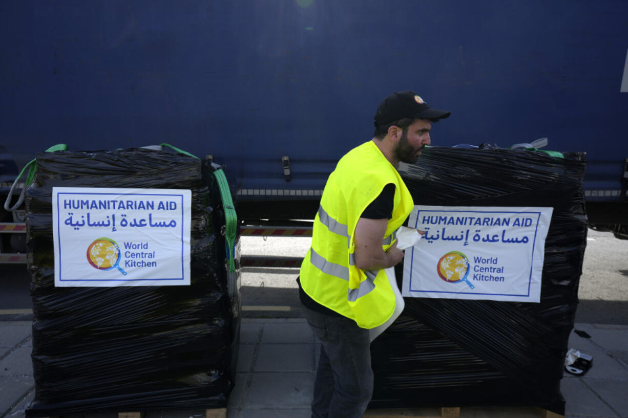 FILE - A member of the World Central Kitchen prepares a pallet with the humanitarian aid for transport to the port of Larnaca from where it will be shipped to Gaza, at a warehouse near Larnaca, Cyprus, on March 13, 2024. World Central Kitchen, the food charity founded by celebrity chef Jos&eacute; Andr&eacute;s, called a halt to its work in the Gaza Strip after an apparent Israeli strike killed seven of its workers, mostly foreigners.