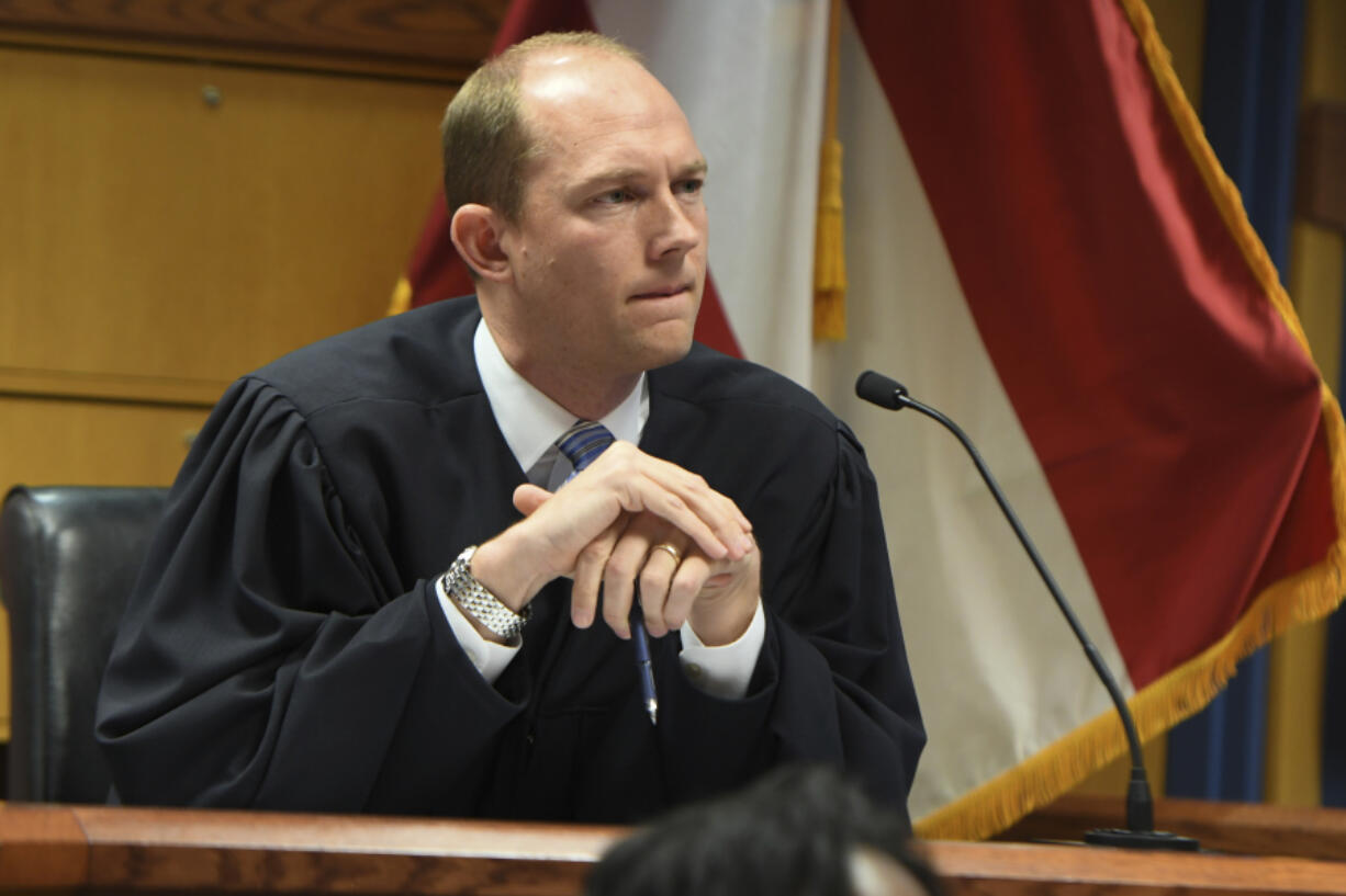 Judge Scott McAfee addresses the lawyers during a hearing on charges against former President Donald Trump in the Georgia election interference case on Thursday, March 28, 2024 in Atlanta.  Lawyers for Trump argued in a court filing that the charges against him in the Georgia election interference case seek to criminalize political speech and advocacy conduct that is protected by the First Amendment.