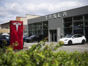 Cars are parked at a Tesla dealership in Berlin Tuesday, April 23, 2024.