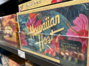 Packages of macadamia nuts are displayed on store shelves on Friday, April 26, 2024, in Honolulu. For decades, tourists to Hawaii have brought home gift boxes of the islands&rsquo; famous chocolate-covered macadamia nuts for friends and family.