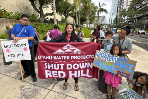 Activists protest before a trial for a mass environmental injury case outside the federal courthouse on Monday, April 29, 2024, in Honolulu. The trial is set to begin Monday more than two years after a U.S. military fuel tank facility under ground poisoned thousands of people when it leaked jet fuel into Pearl Harbor&rsquo;s drinking water.