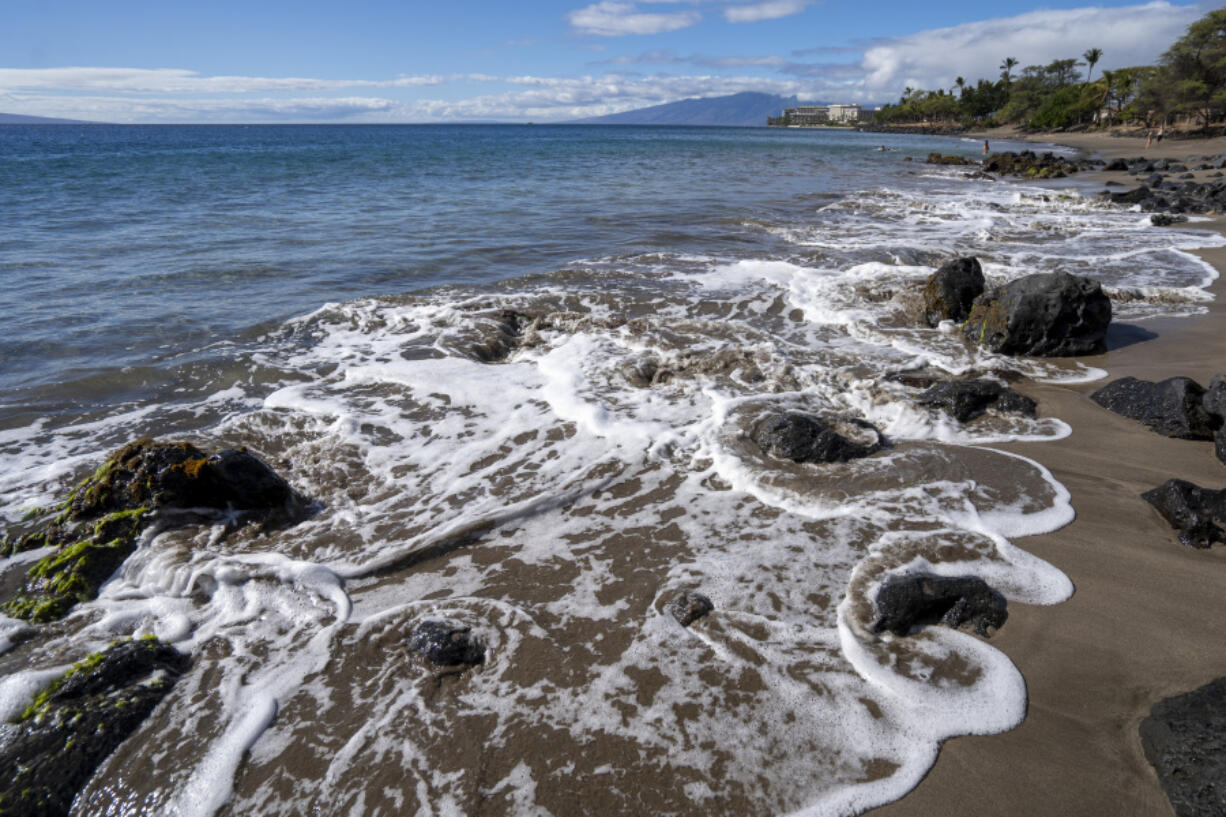 FILE - The tide circulates around rocks as it rises at Wahikuli Wayside Park on Friday, Nov. 3, 2023, in Lahaina, Hawaii. Hawaii authorities said Thursday, April 11, 2024, that coastal waters off the wildfire-stricken town of Lahaina pose no significant risk to human health and it&rsquo;s safe to surf and swim there.