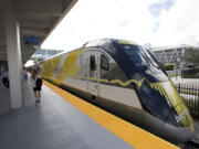 FILE - A Brightline train is shown at a station in Fort Lauderdale, Fla., on Jan. 11, 2018.  A fast-tracked plan to build a high-speed passenger rail line between Las Vegas and the Los Angeles area is set to mark the start of construction. Brightline West and U.S. transportation secretary and other officials projecting that millions of ticket-buyers will be boarding trains by 2028.