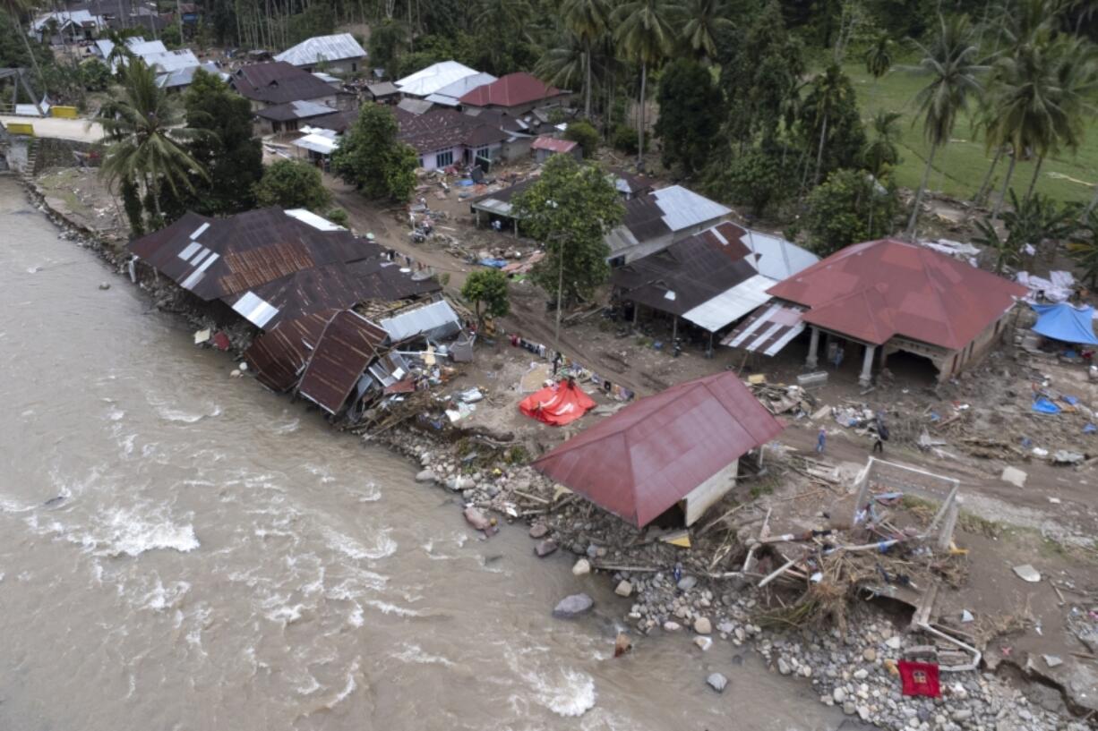 Homes damaged by a flash flood sit in Pesisir Selatan, West Sumatra, Indonesia, Wednesday, March 13, 2024. In Indonesia, environmental groups continue to point to deforestation and environmental degradation worsening the effects of natural disasters such as floods, landslides, drought and forest fires.