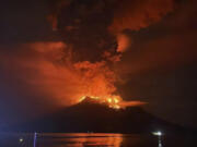 In this photo released by Sitaro Regional Disaster Management Agency (BPBD Sitaro), hot molten lava glows at the crater of Mount Ruang as it erupts in Sanguine Islands, Indonesia, Wednesday, April 17, 2024. Indonesian authorities issued a tsunami alert Wednesday after eruptions at Ruang mountain sent ash thousands of feet high. Officials ordered more than 11,000 people to leave the area.