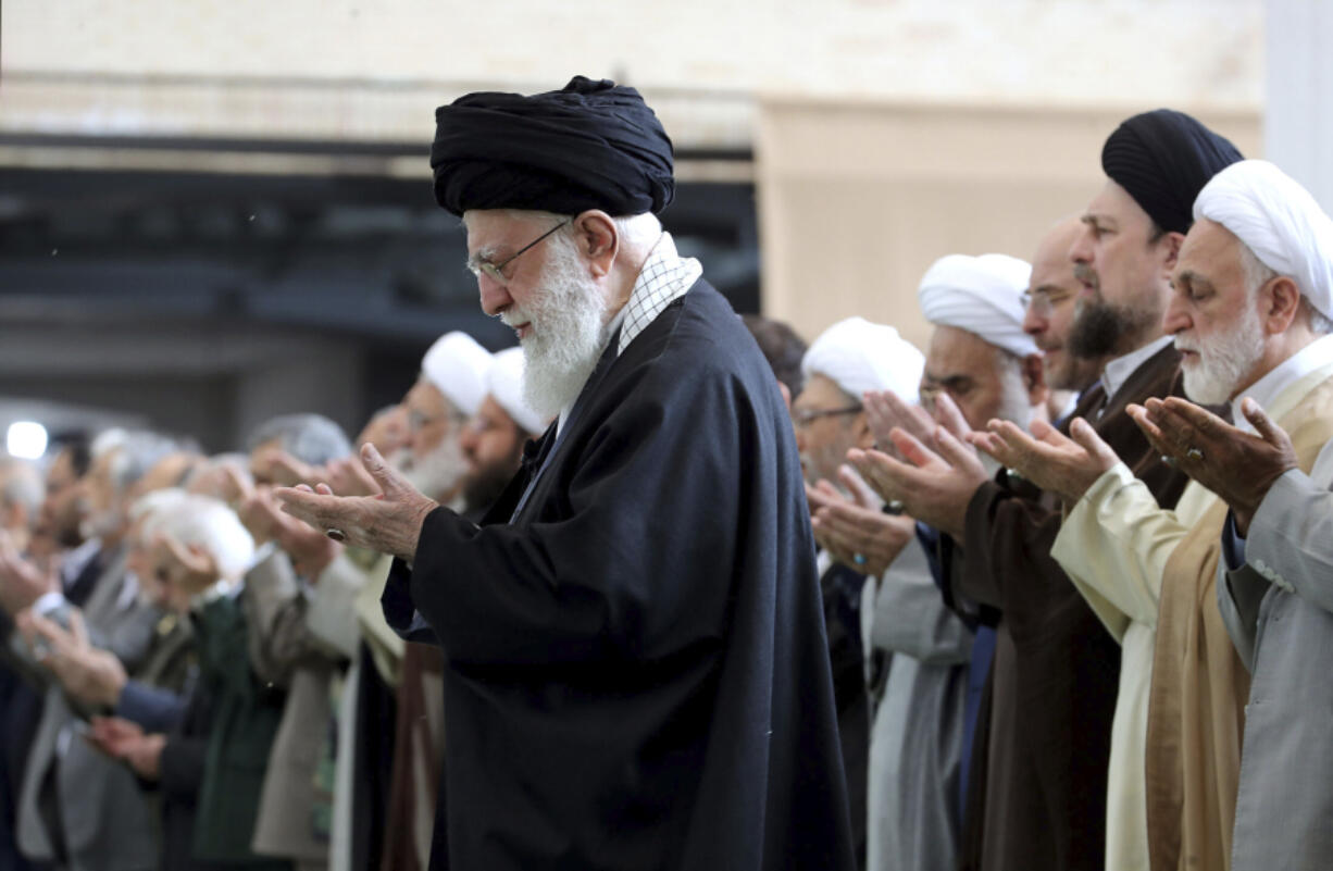In this photo released by the official website of the office of the Iranian supreme leader, Supreme Leader Ayatollah Ali Khamenei leads Eid al-Fitr prayer marking the end of the Muslims holy fasting month of Ramadan, in Tehran, Iran, Wednesday, April 10, 2024. Ayatollah Khamenei reiterated on Wednesday a promise to retaliate against Israel over the killings of Iranian generals in Syria.
