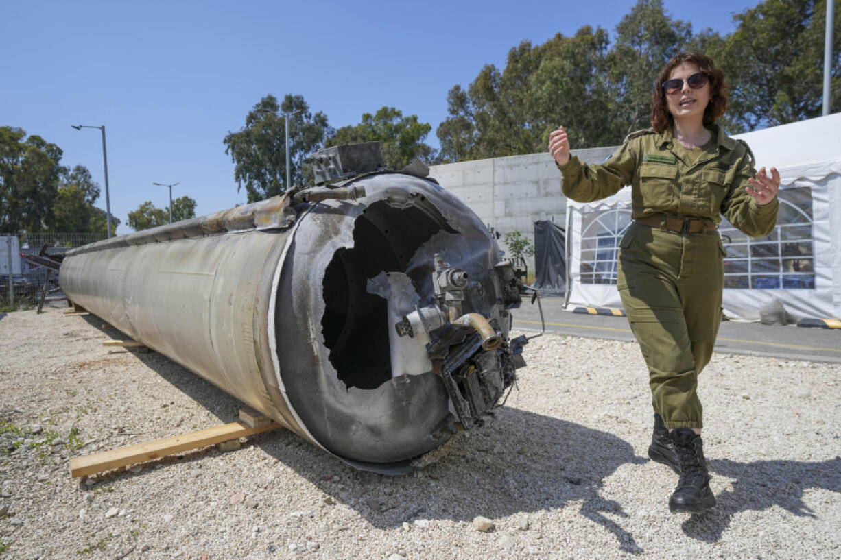 Israeli military deputy head of the IDF International press department, first lieutenant Masha Michelson, display to the media one of the Iranian ballistic missiles Israel intercepted over the weekend, in Julis army base, southern Israel, Tuesday, April 16, 2024. Israel says that Iran launched over 300 missiles and attack drones in the weekend attack. It says most of the incoming fire was intercepted, but a handful of missiles landed in Israel, causing minor damage and wounding a young girl.