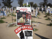 FILE - A poster depicting Israeli-American hostage Hersh Goldberg-Polin is displayed in Re&rsquo;im, southern Israel at the Gaza border, Feb. 26, 2024, at a memorial site for the Nova music festival site where he was kidnapped to Gaza by Hamas on Oct. 7, 2023. Hamas on Wednesday, April 24, 2023, released a recorded video of an Israeli American still being held by the group. The video was the first sign of life of Hersh Goldberg-Polin since Hamas&rsquo; Oct. 7 attack on southern Israel. It was not clear when the video was taken.