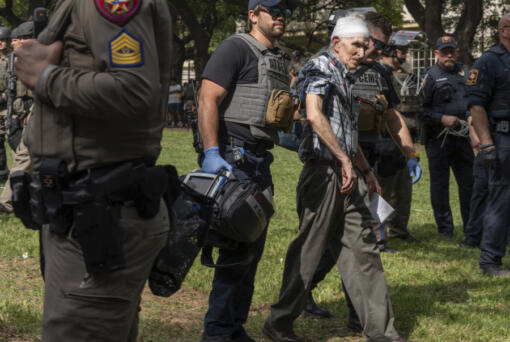 New York Times journalist David Montgomery is walked to be medically evaluated after accidentally being knocked over during a pro-Palestinian protest at the University of Texas, Wednesday April 24, 2024, in Austin, Texas.