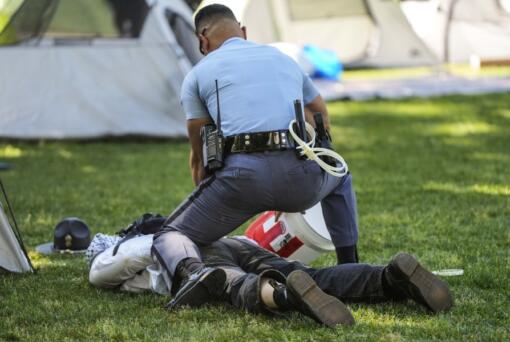 A Georgia State Patrol officer detains a protester on the campus of Emory University during an Israel Palestinian demonstration, Thursday, April 25, 2024, in Atlanta.