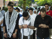 Members of the Muslim community pray while students protest the Israel-Hamas war at George Washington University in Washington, Sunday, April 28, 2024. Protests and encampments have sprung up on college and university campuses across the country to protest the war.