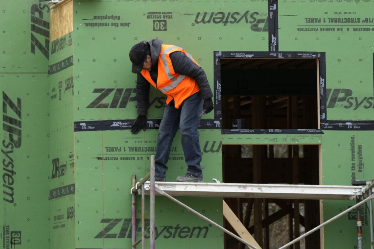 A workman secures sheathing at a residential construction site in Mount Prospect, Ill., Monday, March 18, 2024. On Tuesday, April 2, 2024, the Labor Department reports on job openings and labor turnover for February. (AP Photo/Nam Y.