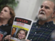 FILE - Larry Woodcock speaks to media members at the Rexburg Standard Journal Newspaper in Rexburg, Idaho on Jan. 7, 2020, while holding a reward flyer for Joshua Vallow and Tylee Ryan. A self-published doomsday fiction author is on trial in Idaho in the deaths of his wife and his new girlfriend&rsquo;s two children. Chad Daybell has pleaded not guilty to murder, conspiracy and grand theft charges in the deaths of his late wife Tammy Daybell, as well as the children, Joshua &ldquo;JJ&rdquo; Vallow and Tylee Ryan.