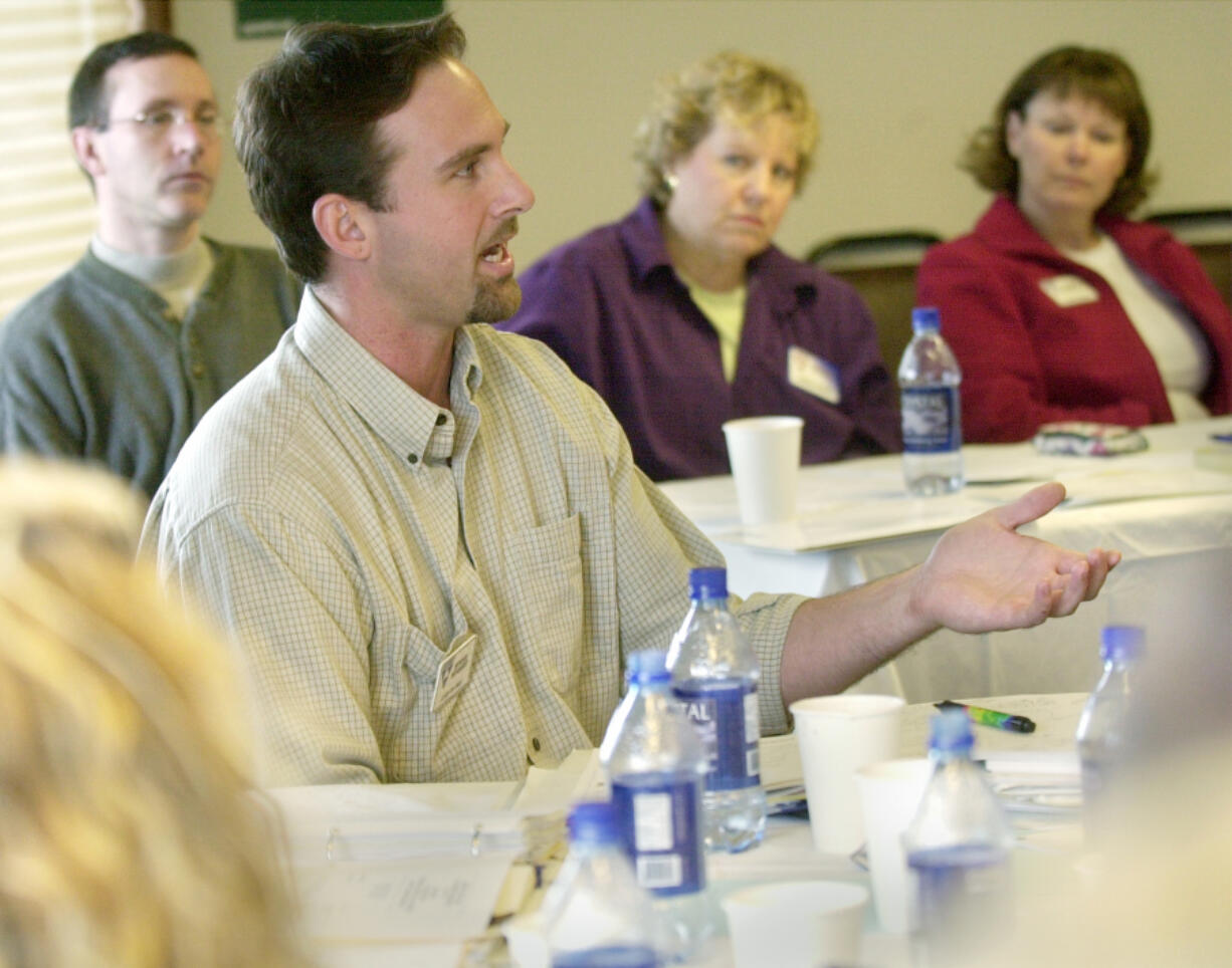 Steve Stuart of Vancouver, center foreground, gestures as he asks a question during a 2003 Leadership Clark County training workshop. He&rsquo;s now Ridgefield city manager.