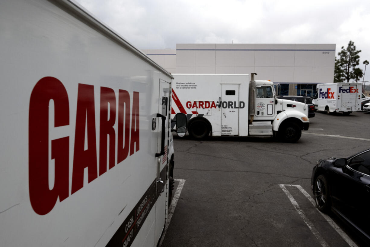 Armored trucks are parked outside the offices of GardaWorld in the Sylmar section of Los Angeles on Thursday. Thieves stole as much $30 million in an Easter Sunday burglary at a Los Angeles money storage facility in one of the largest cash heists in city history.