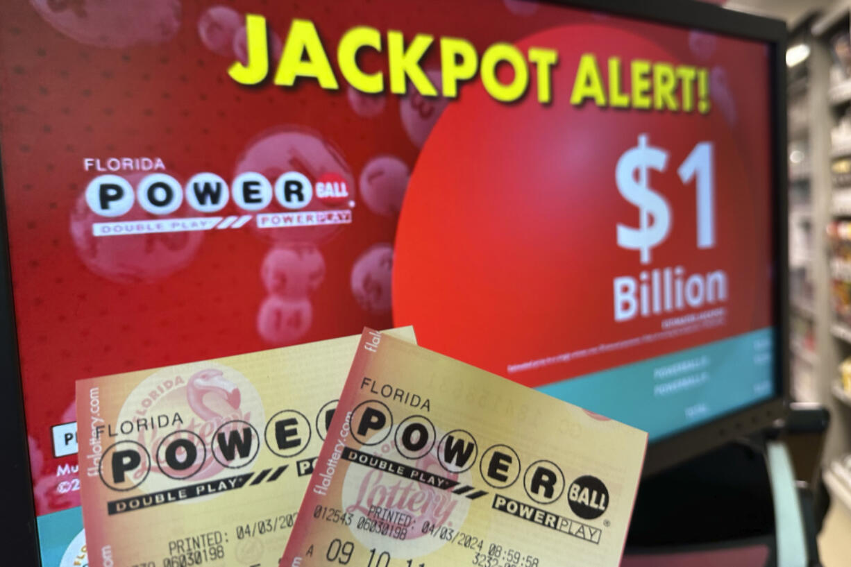 Powerball tickets are shown in front of a screen displaying the estimated jackpot, Wednesday, April 3, 2024, in Surfside, Fla. An estimated $1.09 billion Powerball jackpot that ranks as the 9th largest in U.S. lottery history will be up for grabs Wednesday night, April 3.
