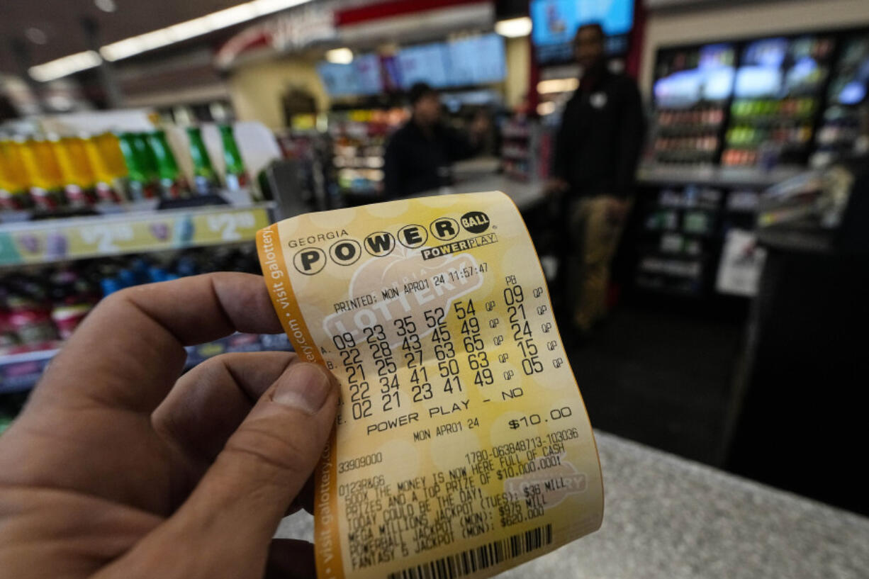 FILE - A Powerball lottery ticket is dipslayed seen inside a convenience store, Monday, April 1, 2024, in Kennesaw, Ga. An estimated $1.09 billion Powerball jackpot that ranks as the 9th largest in U.S. lottery history will be up for grabs Wednesday night,  April 3.