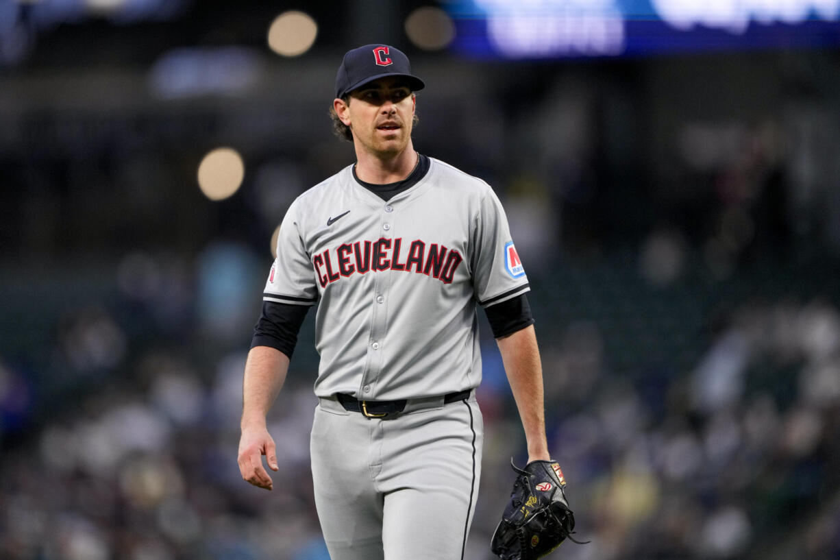 Cleveland Guardians starting pitcher Shane Bieber walks back to the dugout after facing the Seattle Mariners during the first inning of a baseball game Tuesday, April 2, 2024, in Seattle.