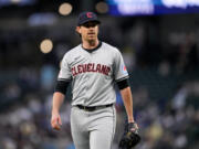 Cleveland Guardians starting pitcher Shane Bieber walks back to the dugout after facing the Seattle Mariners during the first inning of a baseball game Tuesday, April 2, 2024, in Seattle.