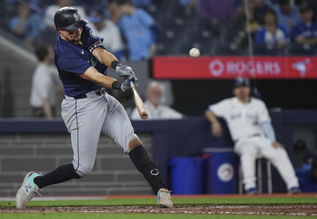 Seattle Mariners catcher Cal Raleigh (29) hits the game winning two run home run during the tenth inning of a baseball game against the Toronto Blue Jays in Toronto on Wednesday, April 10, 2024.