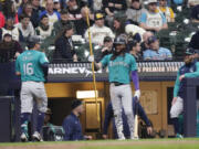 Seattle Mariners&#039; Luis Ur&iacute;as (16) is congratulated at the dugout by J.P. Crawford for a solo home run during the ninth inning of the team&#039;s baseball game against the Milwaukee Brewers on Saturday, April 6, 2024, in Milwaukee.