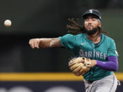 Seattle Mariners&#039; J.P. Crawford throws a runner out at first base during the third inning of a baseball game against the Milwaukee Brewers Saturday, April 6, 2024, in Milwaukee.