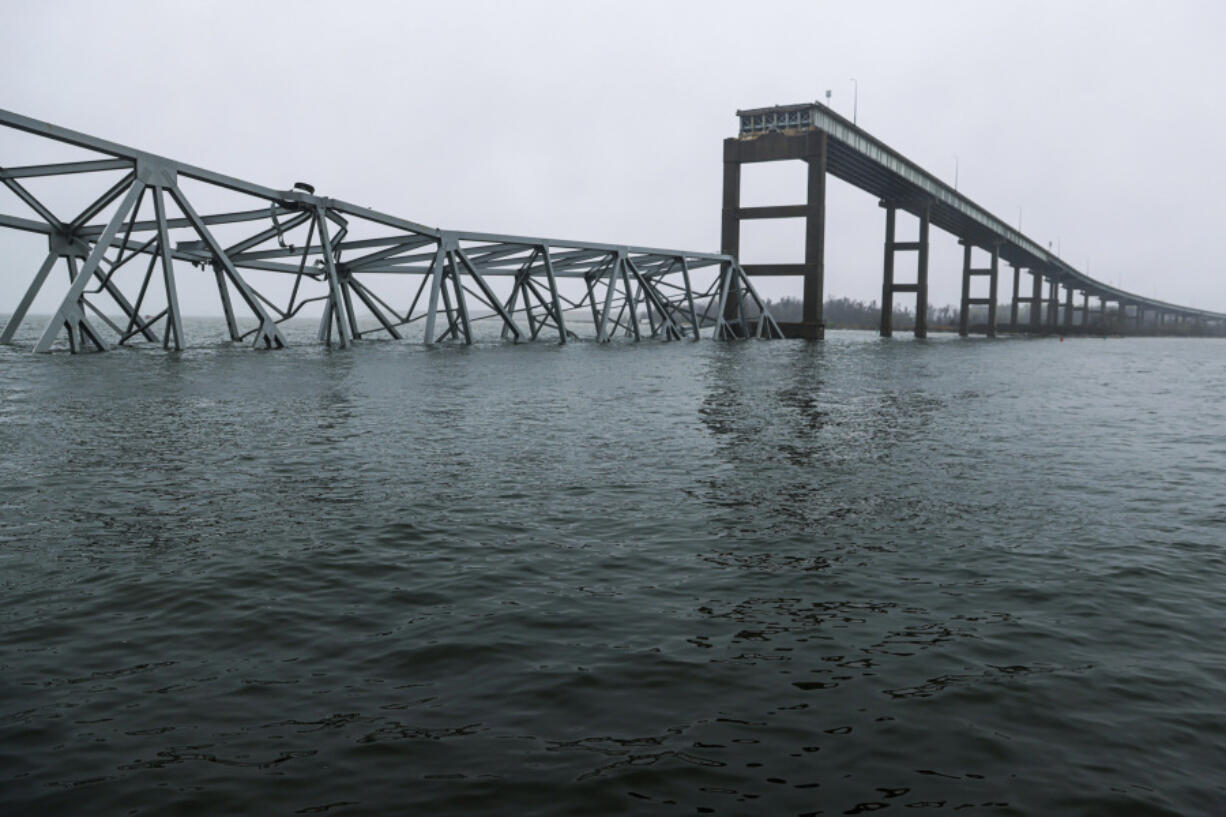 Part of the collapsed Francis Scott Key Bridge stand, Wednesday, April 3, 2024, in Baltimore.