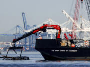 The U.S. Army Corps of Engineers debris removal vessel The Reynolds works near the collapsed Francis Scott Key Bridge, Monday, April 15, 2024, in Baltimore. The FBI confirmed that agents were aboard the Dali conducting court-authorized law enforcement activity.