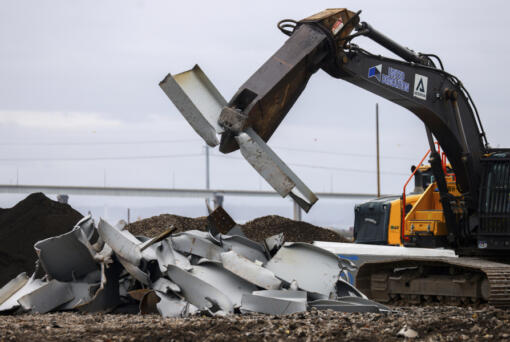 A shearer breaks apart salvaged pieces of the collapsed Francis Scott Key Bridge at Tradepoint Atlantic, Friday, April 12, 2024, in Sparrows Point, Md.