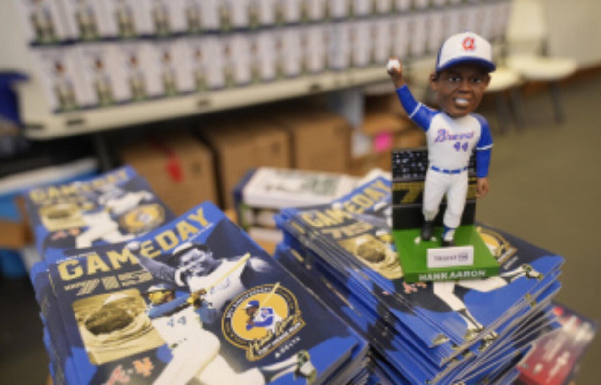 A Hank Aaron bobblehead commemorating the 50th anniversary of Aaron breaking Babe Ruth&rsquo;s career home run record is shown before a baseball game between New York Mets and Atlanta Braves Monday, April 8, 2024, in Atlanta. Aaron hit his 715th home run on April 8, 1974.