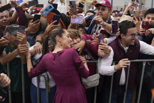 FILE - Presidential candidate Claudia Sheinbaum greets supporters as she arrives to her opening campaign rally at the Zocalo in Mexico City, March 1, 2024. Sheinbaum, a former mayor of Mexico City and the governing party&rsquo;s candidate, has kept a comfortable lead in all polls over her two opponents.